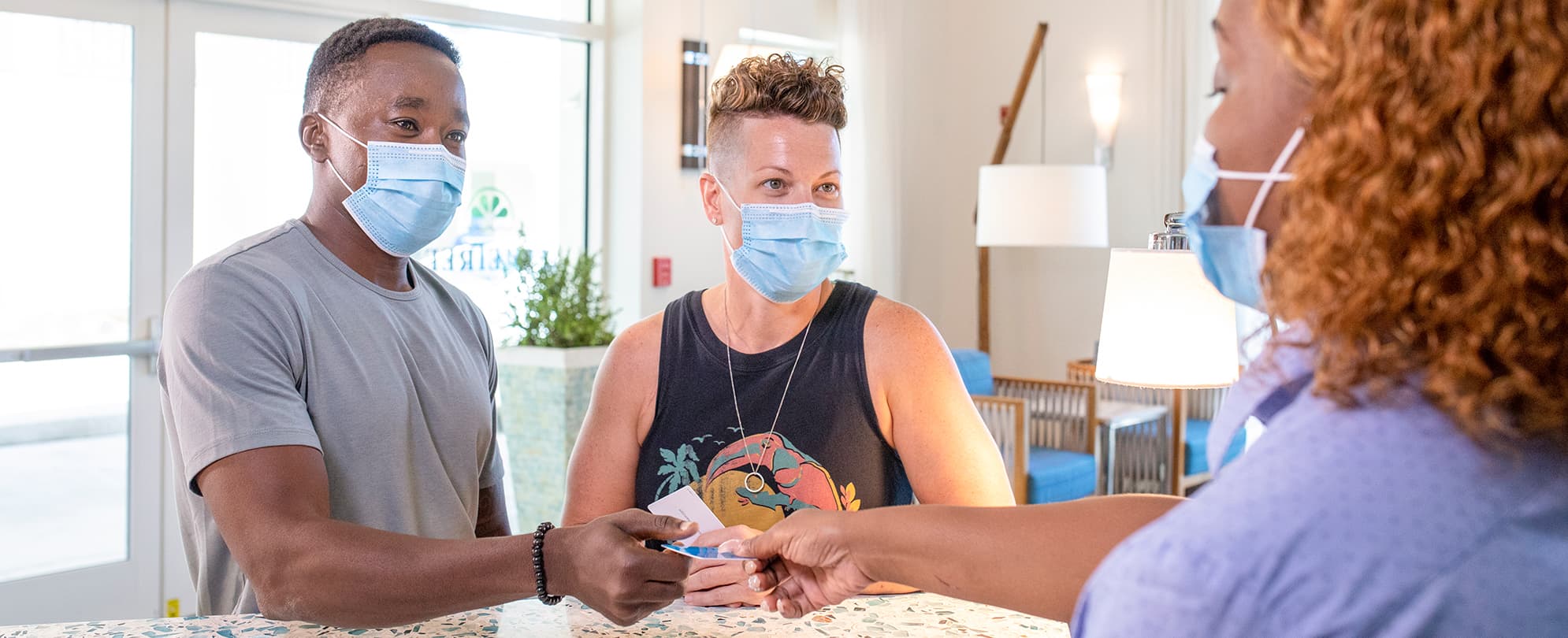 Couple wearing masks check-in to a Wyndham resort 