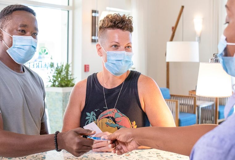 Couple wearing masks check-in to a Wyndham resort 